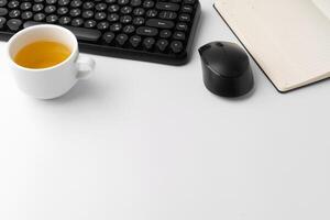 Minimalistic white workplace with keyboard and notebook photo