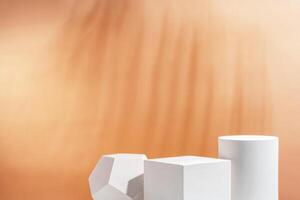 White geometric shapes arranged stylishly on a soft peach background in a minimalist setting photo