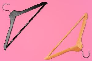 Flat lay composition with empty hangers on pink background photo