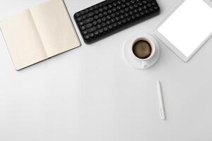 Minimalistic white workplace with keyboard and notebook photo