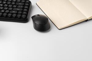 Minimalistic white workplace with keyboard and notebook photo