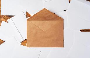 Stack of envelopes on working desk top view. Business mail photo