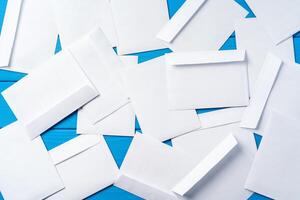 Stack of envelopes on working desk top view. Business mail photo