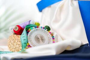 Crafting supplies arranged on a wooden table with colorful threads photo