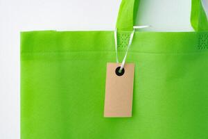 Eco bag for shopping with blank tag on white background photo