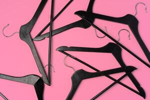 Flat lay composition with empty hangers on pink background photo