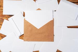 Stack of envelopes on working desk top view. Business mail photo