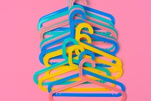 Flat lay composition with empty hangers on pink background photo