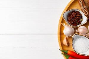 Various spices on white wooden background, close up. photo