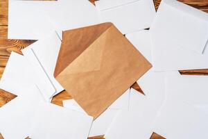 Stack of envelopes on working desk top view. Business mail photo