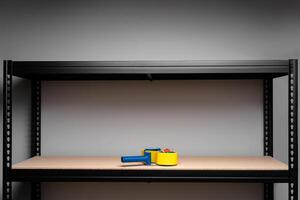 Scotch tape on the shelf of metal rack photo