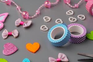 Crafting materials and tools arranged on a gray surface during a creative project photo