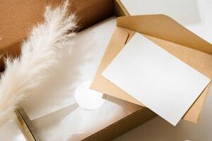 Delivery package with a blank envelope and decorative elements on a light background photo