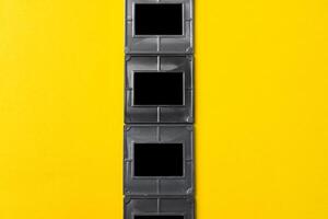 Photography empty slide frames on yellow background photo