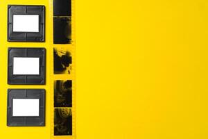 Photography empty slide frames on yellow background photo
