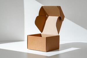 An open cardboard box rests on a bright white surface with soft shadows photo
