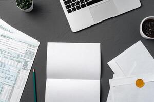 Mail envelope, coffee, pen and laptop on the desk. photo