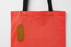 Eco bag for shopping with blank tag on white background photo