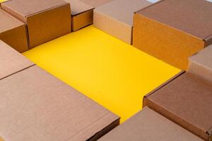 Beige cardboard boxes on yellow background, close up photo