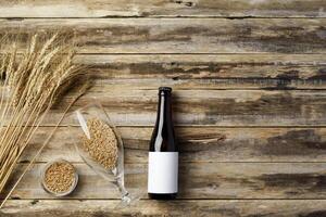 A bottle of beer and grain. Top view. Free space for text. photo