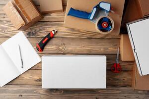 Packing products for delivery on wooden table, top view photo