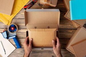 Packing products for delivery on wooden table, top view photo