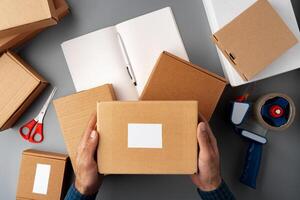 Above table top view of warehouse preparing post courier delivery package photo