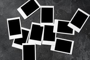Paper photo frames with blank space on gray textured background