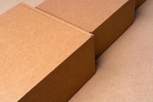Cardboard box on beige background in studio photo
