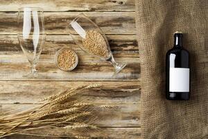 A bottle of beer and grain. Top view. Free space for text. photo
