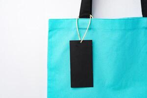 Eco bag for shopping with blank tag on white background photo