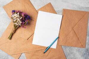 envelope and blank paper card with copy space mock up. photo