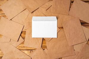 Stack of envelopes on working desk top view. Business mail photo