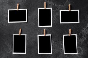 Paper photo frames with blank space on gray textured background