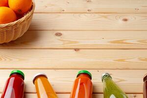 Different bottles of juice on wooden table photo