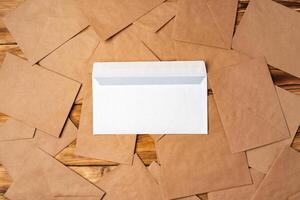 Stack of envelopes on working desk top view. Business mail photo