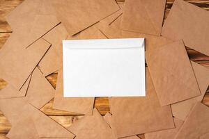 Stack of envelopes on working desk top view. Business mail photo