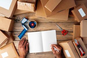 Packing products for delivery on wooden table, top view photo