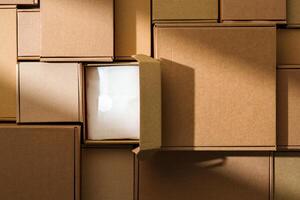 Stacked cardboard boxes arranged in a neat pattern under natural light photo