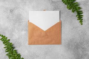 envelope and blank paper card with copy space mock up. photo