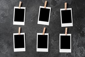 Paper photo frames with blank space on gray textured background