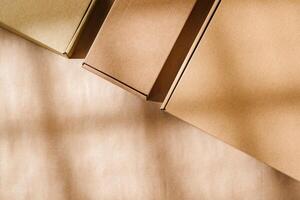 Brown cardboard boxes arranged on a neutral background in a warehouse setting during daylight hours photo