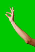A womans hand extends upward into the air, fingers outstretched, reaching upward towards an unseen destination. photo