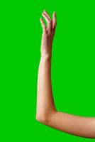 Hand Reaching Up on Green Background photo