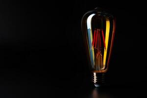 Light bulb on black background close up photo