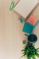 Top view workspace with blank notebook and pen on wooden table photo
