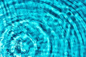 Clear turquoise pool water glistens under sunlight with gentle ripples photo