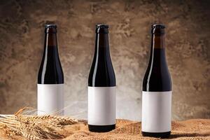 Beer bottle with blank label against gray textured background photo