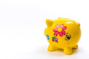 yellow piggy bank isolated on white photo