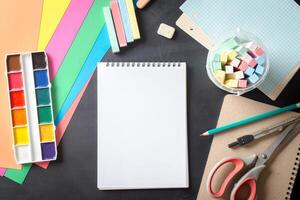 Watercolor paints set with brushes and paper sheet photo